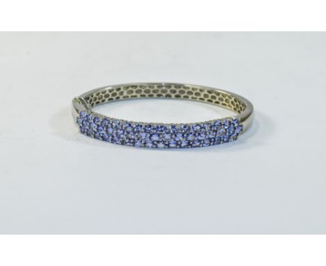 A Nice Quality Silver Set Tanzanite Hinged Bangle. Fully Hallmarked, Set with Over 50 Tanzanite's, Est for 2.5ct. Excellent C