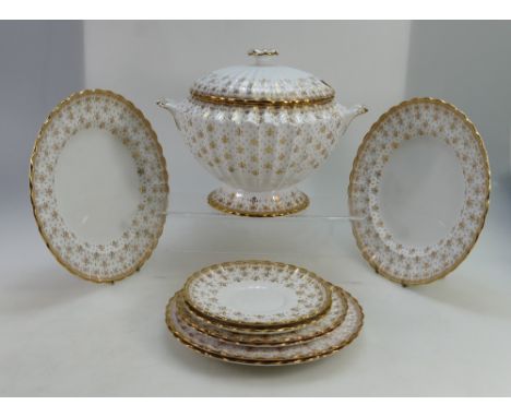 A good collection of Spode dinnerware in the Fleur de Lys Gold pattern to include dinner plates, side plates, tureen, saucers