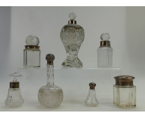 A collection of vintage silver topped crystal glass scent bottles (7)