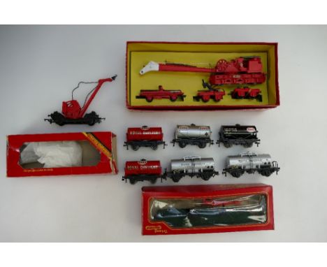 A collection of Hornby carriages and tank wagons to include Breakdown crane, Helicopter car, Operating crane truck, ESSO and 