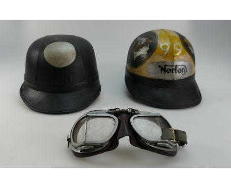 1950's Compton and AviaKit cork motor cycle helmet the latter with Norton Motor Cycles decoration together with leather mount