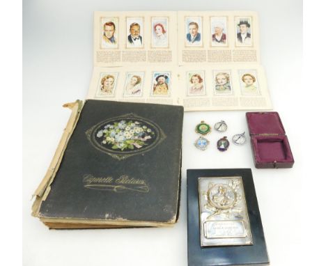 A collection of old cigarette cards, dancing trophy and various silver and enamel dancing medals