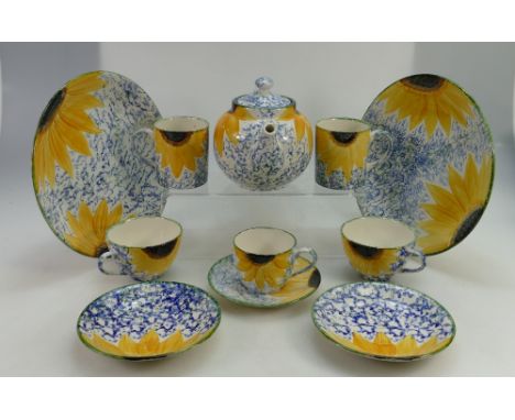 A collection of modern Poole pottery hand painted dinnerware to include cups, saucers, dinner plates, etc.