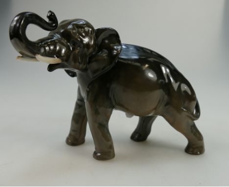 Royal Doulton model of an elephant with trunk in salute, in natural colour, height 14cm (end of tusk chipped)