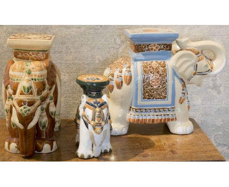 CERAMIC ELEPHANTS, a group of three in the manner of Thomas Goode, largest 45cm H x 55cm L. (3)