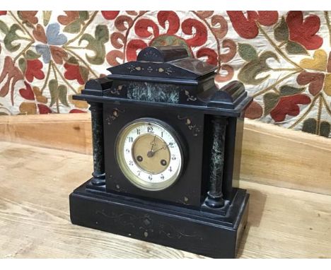 A 19thc slate mantel clock of typical form, with enamel dial with arabic numerals and trefoil hands (32cm x 30cm x 14cm)
