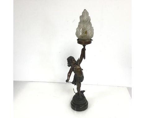 A spelter table lamp in the form of  Aros, holding a Torch, the opaque glass shade in the form of flames (a/f) (h.49cm)