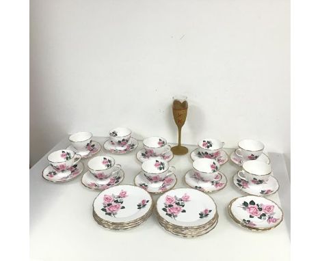 A set of ten tea cups, with pink rose and gilt decoration with twelve saucers and side plates (cup: 7cm x 11cm x 9cm) with a 