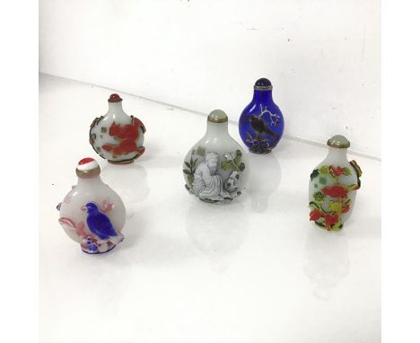 A group of Chinese snuff bottles, three depicting birds on branches, one with squirrels and a monkey and one with scholars, o