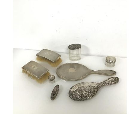 A selection of dressing table items including two engine turned brushes and mirror (30cm x 12cm), lidded jars, nail buffer, a