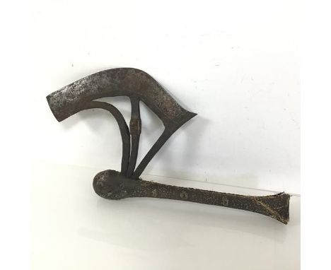 An African ceremonial axe with incised curved blade and detail of figure masks to each side, on a lizard skin covered handle 