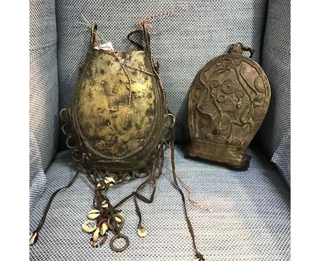 A Benin brass hanging pouch, decorated with snakes and with hanging cowrie tassles (29cm x 22cm) together with a further bras