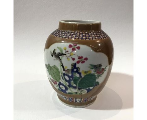 An early 20thc Chinese baluster vase decorated with bird and floral design, enclosed within chocolate coloured cartouches wit