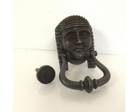 A patinated metal door knocker in the form of an Egyptian pharoah (19cm x 10cm)