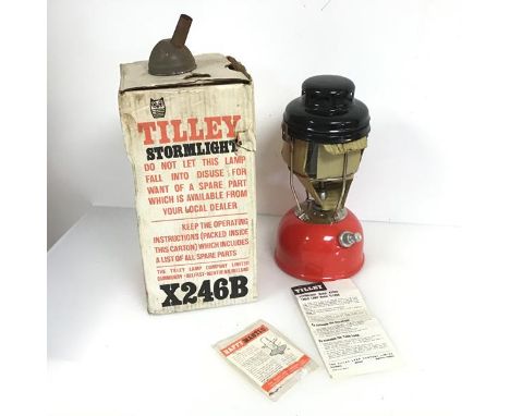 A Tilley storm light, model X246B, having a red base and complete with original box and papers (34cm x 17cm)