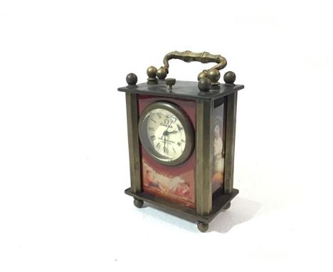 An Omega brass mounted miniature four glass style clock, with glazed panels depicting famous historical figures, with enamel 