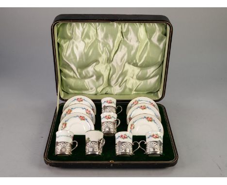 AN EARLY TWENTIETH CENTURY CASED SUITE OF SIX GEORGE JONES (Crescent China) PORCELAIN COFFEE CUPS, with silver pierced cup ho