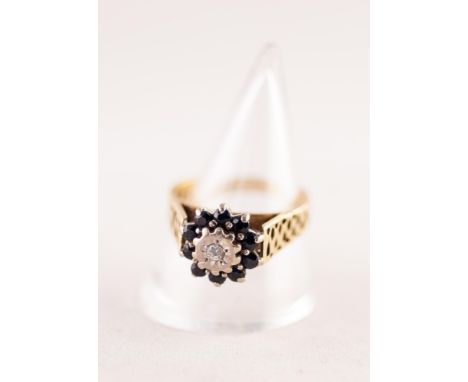 18ct GOLD CLUSTER RING SET WITH A SMALL CENTRE DIAMOND in a deceptive setting and surround of ten small sapphires, pierced sh