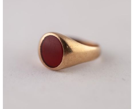 CARNELIAN SIGNET RING. Oval carnelian in a rubbed over setting, to a tapered shank, stamped '9CT', ring size R, 4.24g Good co