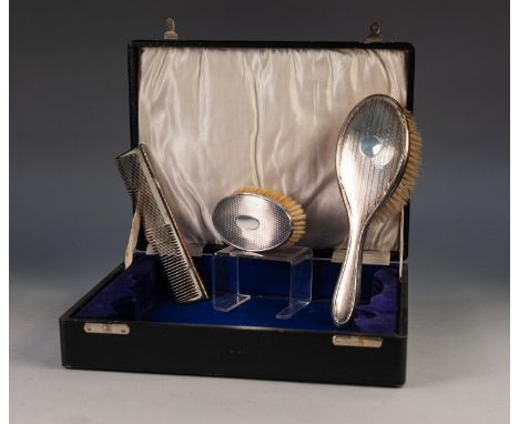 GEORGE V ENGINE TURNED SILVER BACKED HAIR BRUSH AND COMB, Birmingham 1928, together with a SIMILAR OVAL MILITARY HAIR BRUSH, 