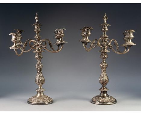 IMPRESSIVE PAIR OF FIVE LIGHT ELECTROPLATED TWO PIECE CANDELABRA, each with four scroll arms and central flame snuffer to the