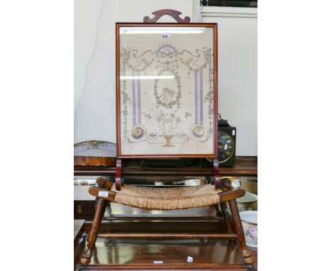 A mahogany fire screen with cherubs beneath the lace panel, together with a rush seated stool (2)