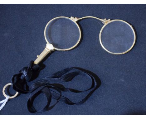 A pair of late 19th/early 20th century lady's gold-plate lorgnettes, of typical form, engine-turned throughout, 11.5cm long, 