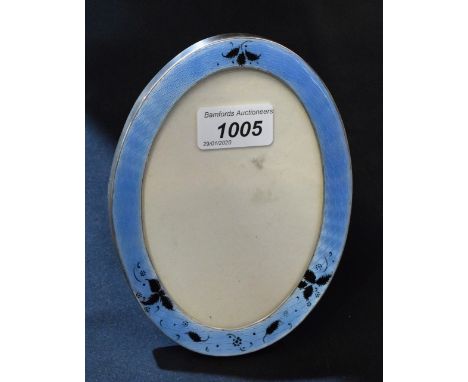 A George V silver and enamel oval easel photograph frame, 17cm high, Birmingham 1911