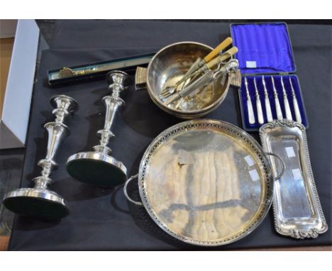 A pair of silver on copper candlesticks; an EPNS wick trimmer on tray; a set of lobster picks, mother-of-pearl hafted, cased;