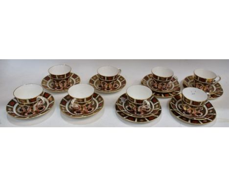 A set of eight Royal Crown Derby 1128 pattern coffee cups and saucers; four side plates