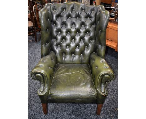A Chesterfield type wingback reception armchair, deep button upholstery, 106.5cm high