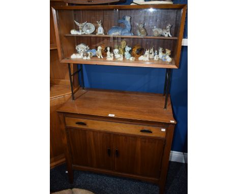 A retro mid-20th century sideboard, rectangular top with sliding glass doors enclosing a shelf, tubular metal supports, the b