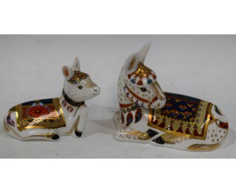 A Royal Crown Derby paperweight, Thistle Donkey, gold stopper; another, Holly Donkey Foal, gold stopper (2) Condition Report: