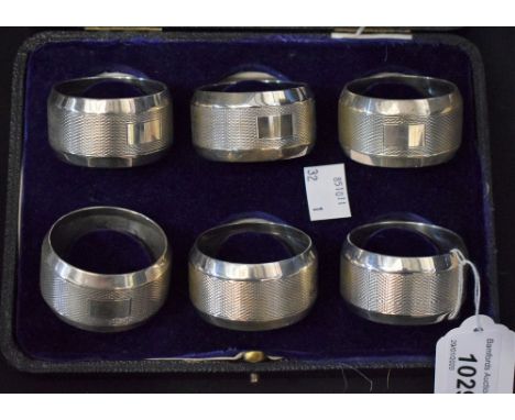 A set of six substantial George V silver napkin rings, engine turned, 5cm diam, Birmingham 1931, cased