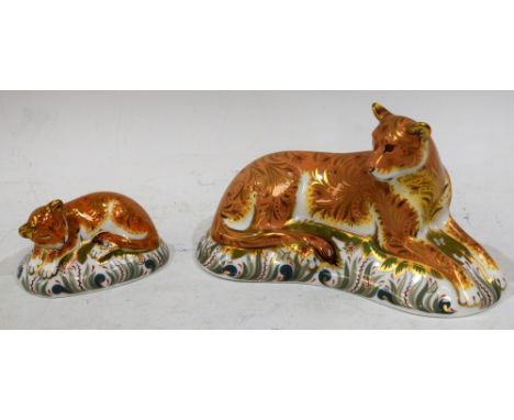 A Royal Crown Derby paperweight, Lioness, gold stopper, boxed; another, Lion Cub, gold stopper, boxed (2) Condition Report: B