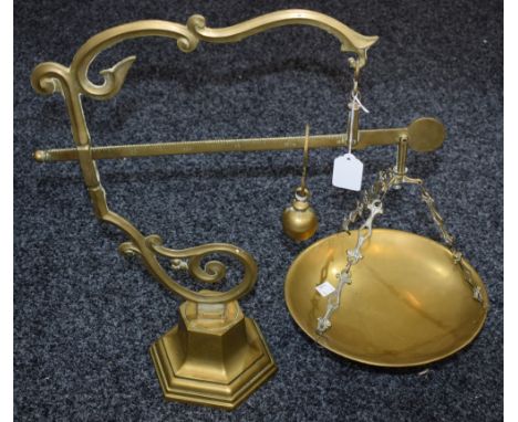 A 19th century French brass farm/shop balance scale, fixed sawtoothed bar with slide action counter weight, ornate hexagonal 