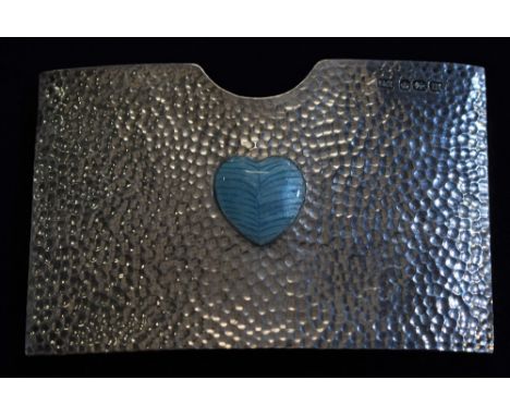 An Arts and Crafts silver and enamel curved rounded rectangular card case, decorated with a heart motif on a planished ground