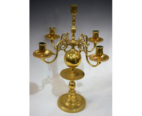 A William &amp; Mary style brass five-light table centre candelabrum, scroll branches, waisted sconces, dished circular drip 