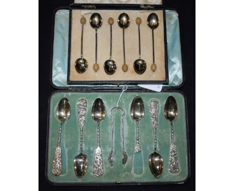 A set of six Chinese silver teaspoons, openwork handles, sugar tongs, boxed, Dublin retailer; a set of six enamelled silver s