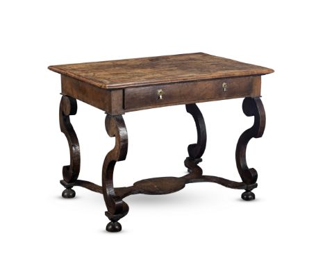 A Dutch late 17th century and later walnut side tableThe crossbanded top above a frieze drawer on scrolled legs united by a s