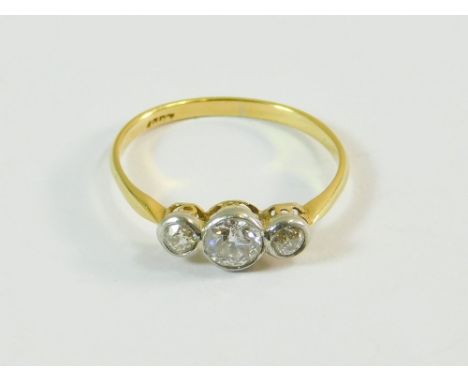 DIAMOND RING. An 18ct. gold, collet-set three stone diamond ring. The central stone of approx. 0.25ct. spread. Size K/L.  Not