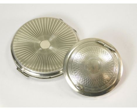 SILVER COMPACTS. An engine turned small silver compact (diameter 5cm) & a sterling silver larger compact, 6cm.  Please note t