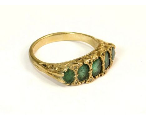 GOLD RING. A modern 9ct. gold dress ring, set a row of five emerald coloured stones interspersed with diamond chips. Size M/N