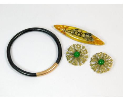 ART DECO BROOCH ETC. An Art Deco carved celluloid brooch mounted with brass, length 9cm. Also, an Art Deco celluloid slave ba