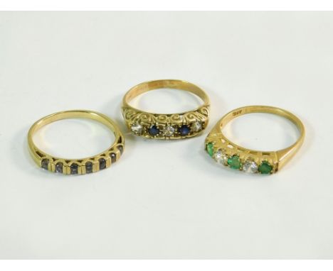 GOLD RINGS. Three 9ct. gold rings: a five stone emerald & diamond ring; a five stone diamond & sapphire ring & a half-hoop et