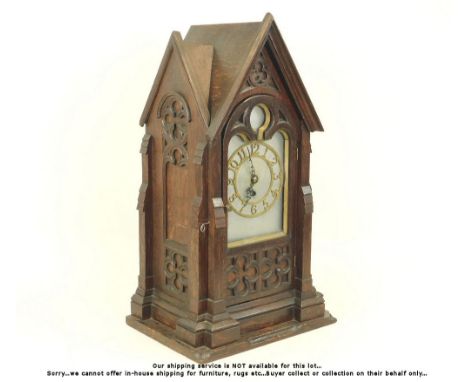 TABLE CLOCK. A large Victorian Gothic inspired oak table clock with brass chapter ring. H70 x W79 x D29cm. Please note: We ca