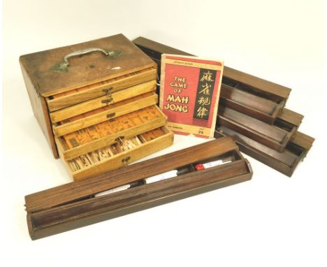 MAHJONG SET.A mahjong set in a five drawer cabinet, the tiles of amber coloured bakelite, the sticks of bone, comprising 147 