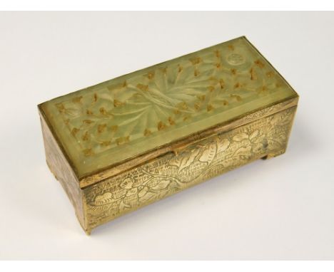 STAMPS BOX. A Chinese brass, twin compartment stamps box, with pierced jade lid. Length 7.6cm.