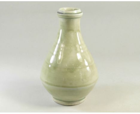 MIKE DODD. A gloss celadon glaze bottle vase. Impressed mark. Height 19cm.