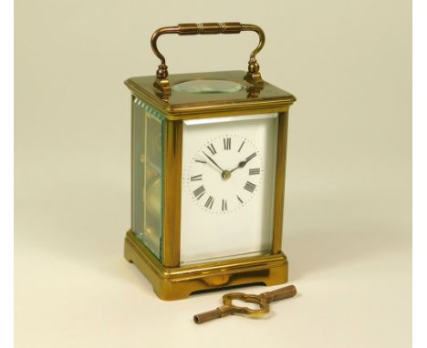 CARRIAGE CLOCK. A French brass cased carriage clock with key. Height excl. handle 11cm.